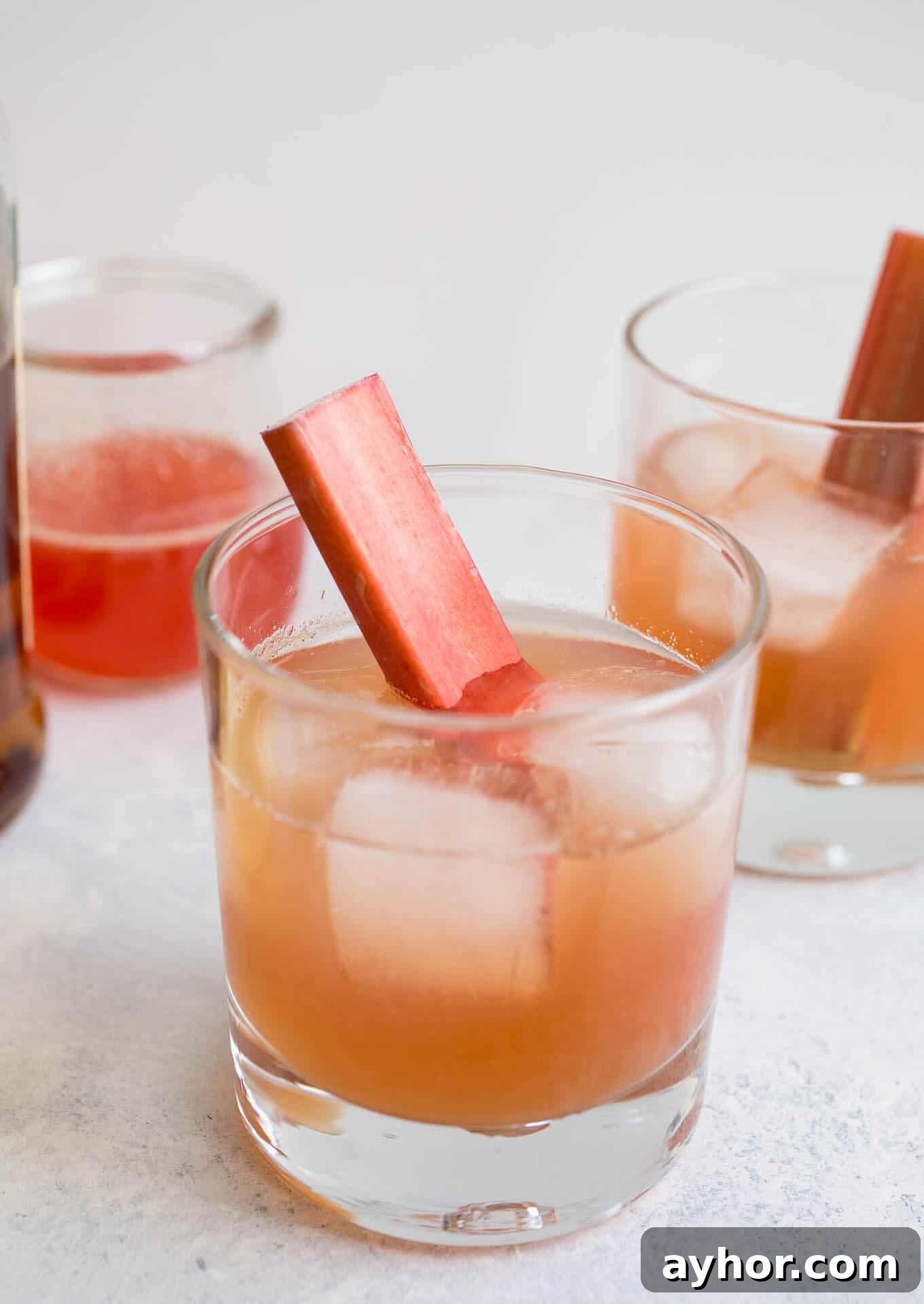 Rhubarb Bourbon Sour: Spring Cocktail Recipe with Rye Twist 2 Bourbon sour in a glass with ice cubes.