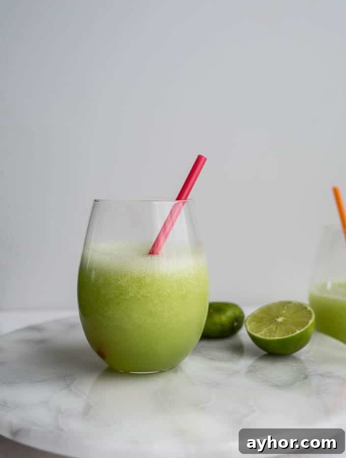 A honeydew daiquiri on a marble platter.