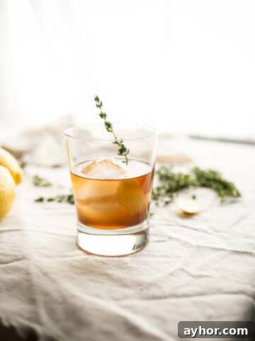 old fashioned cocktail with thyme garnish