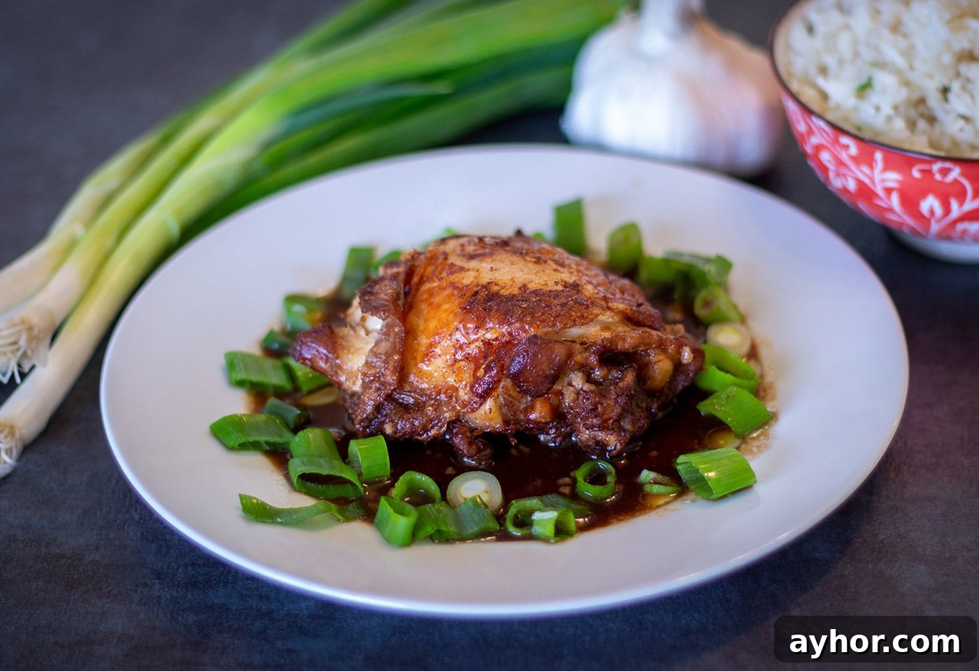 Instant Pot Chicken and Cabbage Dinner Recipe 5 Instant Pot Crispy Chicken Adobo on a white plate with scallions, garlic and white rice