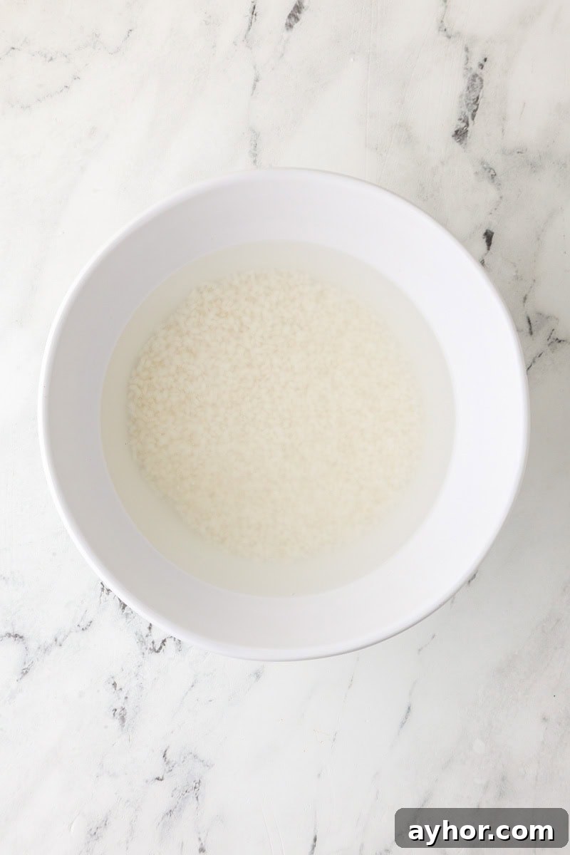 Mango Sticky Rice with Coconut Cream: Authentic Thai Dessert Recipe 6 Sticky rice soaking in water in a bowl before cooking.