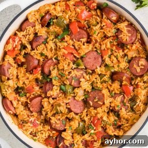 This Sausage and Rice Skillet features smoky sausage sizzled with sweet bell pepper, onions, and garlic in vibrant tomato sauce.