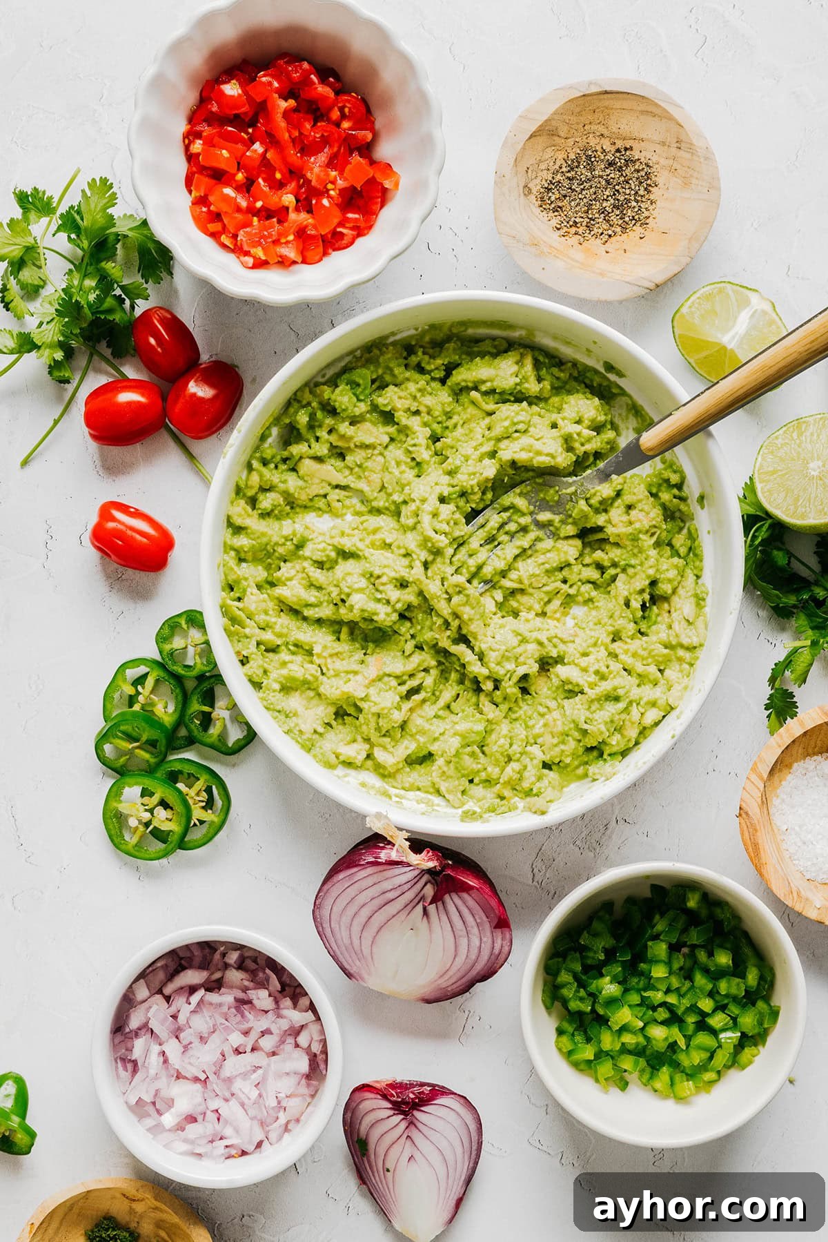 The BEST Chunky Guacamole recipe made with ripe avocados, crisp veggies, zesty lime juice and a kick of heat that you can easily throw together in just minutes! Perfect for summer barbecues, game day parties, taco nights or simply craving a fresh snack.