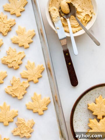 Spreading maple butter filling on maple shortbread to sandwich together and make maple cream cookies.