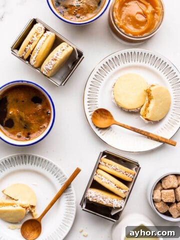 Homemade alfajores cookies on plates served with coffee.