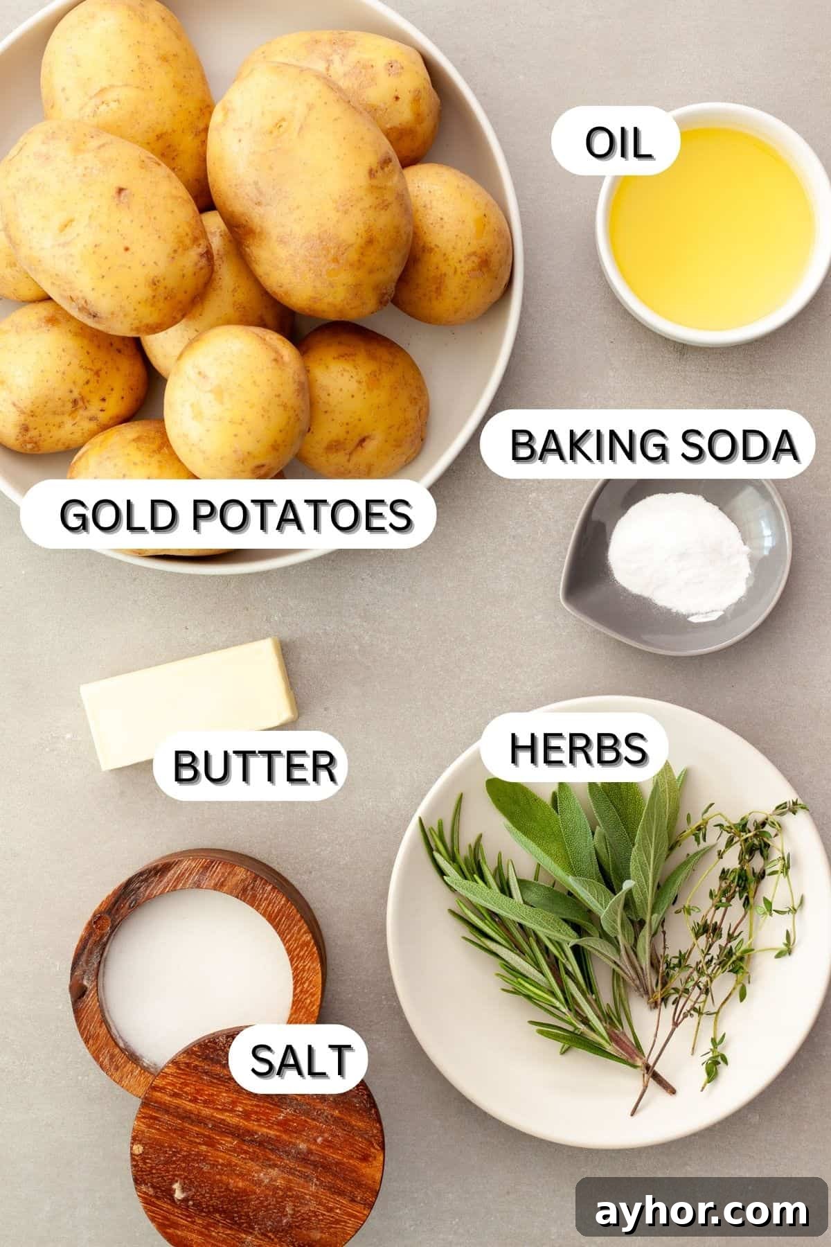 Ingredients for crispy herb roasted potatoes on a gray table.