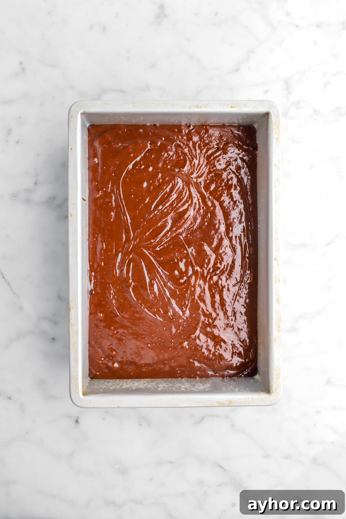 brown batter in rectangular cake pan.
