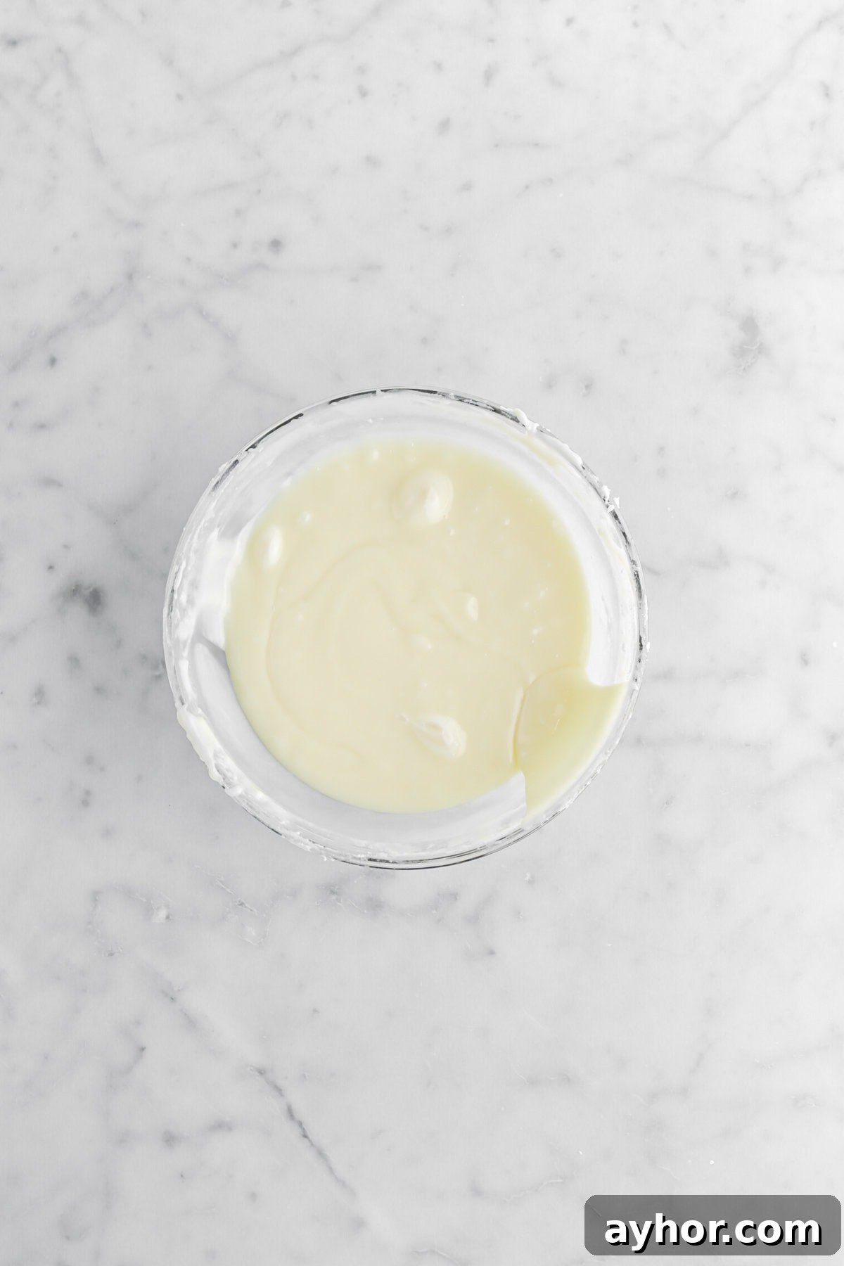 white chocolate ganache in glass bowl.