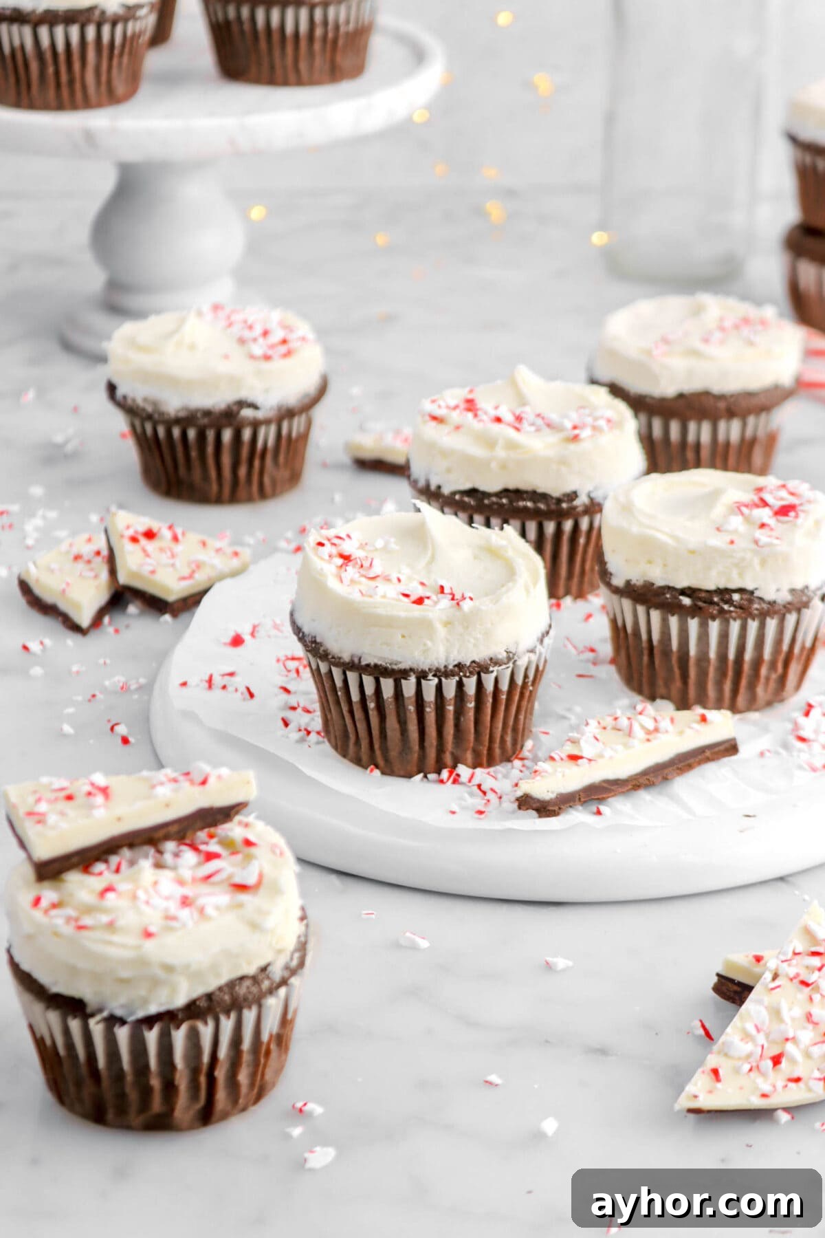 three peppermint bark cupcakes on plate