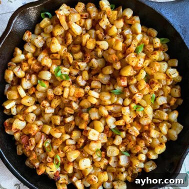 Quick Garlic Toast Recipe for Crispy, Flavorful Slices 11 A close-up of blackened, sautéed corn kernels garnished with fresh green onions, served in a cast iron skillet.