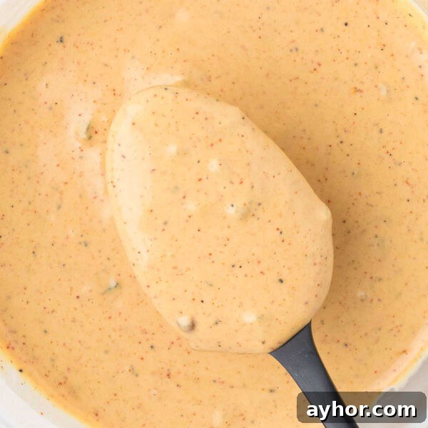 Alabama White BBQ Sauce Recipe: Tangy Homemade Chicken & Pork Glaze 11 Creamy sauce with black pepper flecks, perfect for dipping or drizzling.
