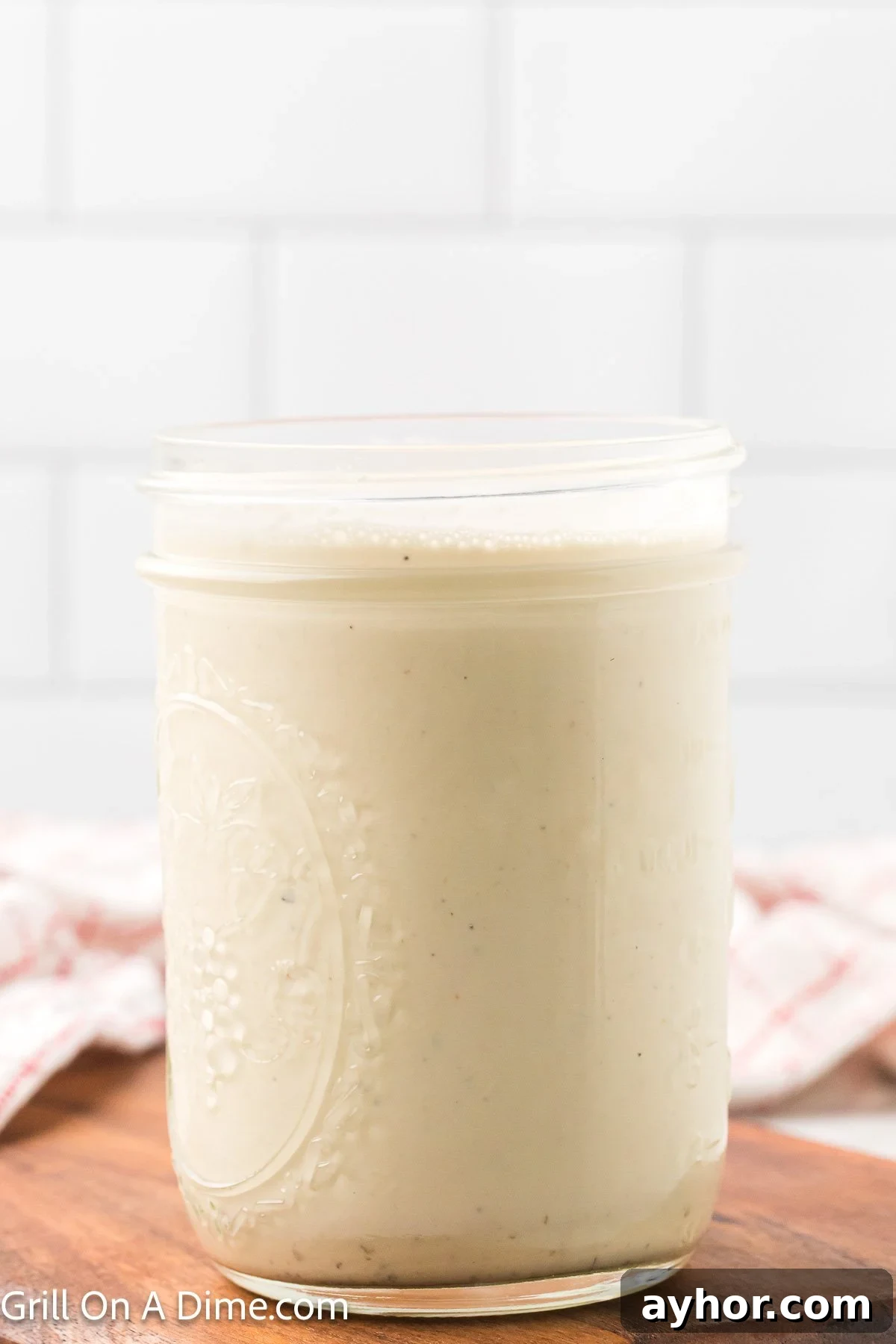 Alabama White BBQ Sauce Recipe: Tangy Homemade Chicken & Pork Glaze 7 White sauce in a glass mason jar