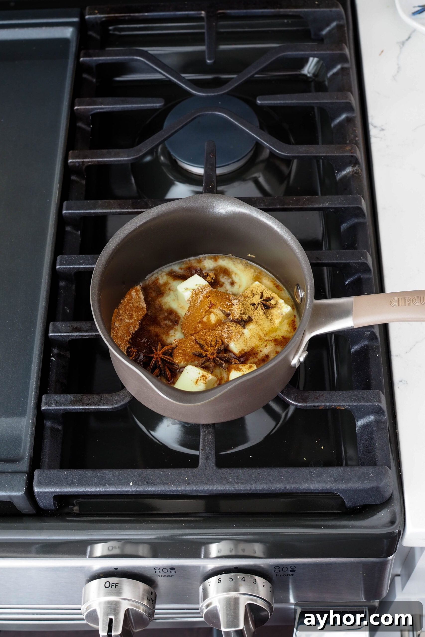 Caramel Chai Muffins Recipe — Warm Spiced Muffins with Caramel 5 Butter melts in a small saucepan with warm spices floating in it.