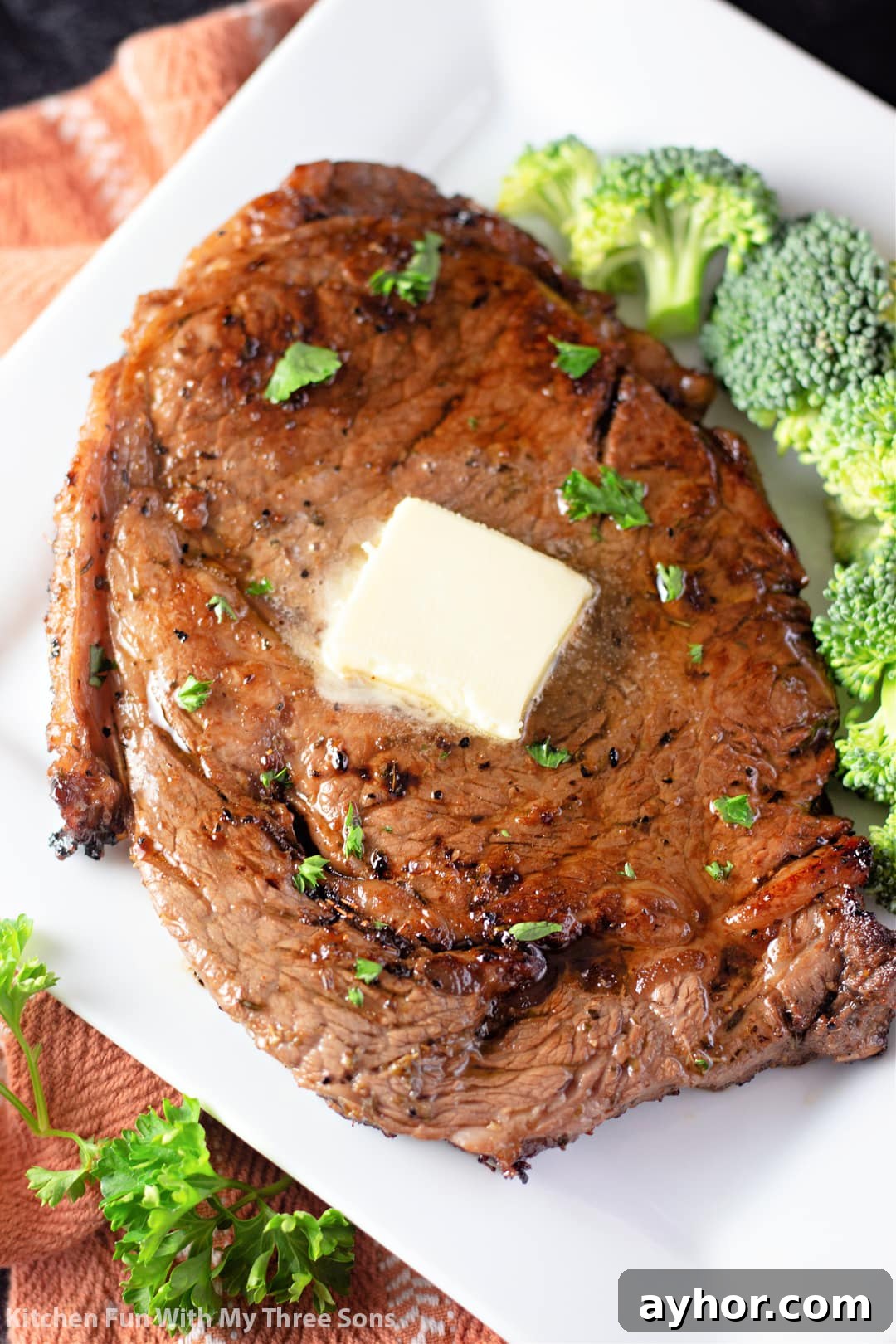 freshly made steak with butter and broccoli.