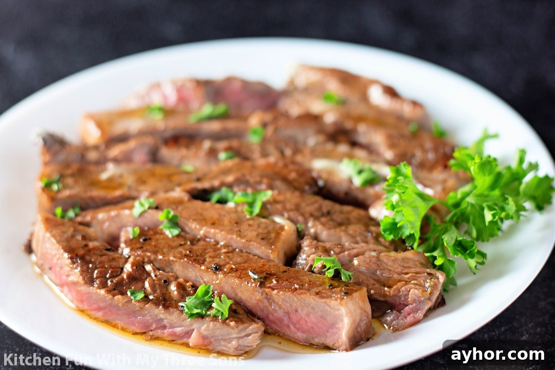 steak cut into strips on a white plate.