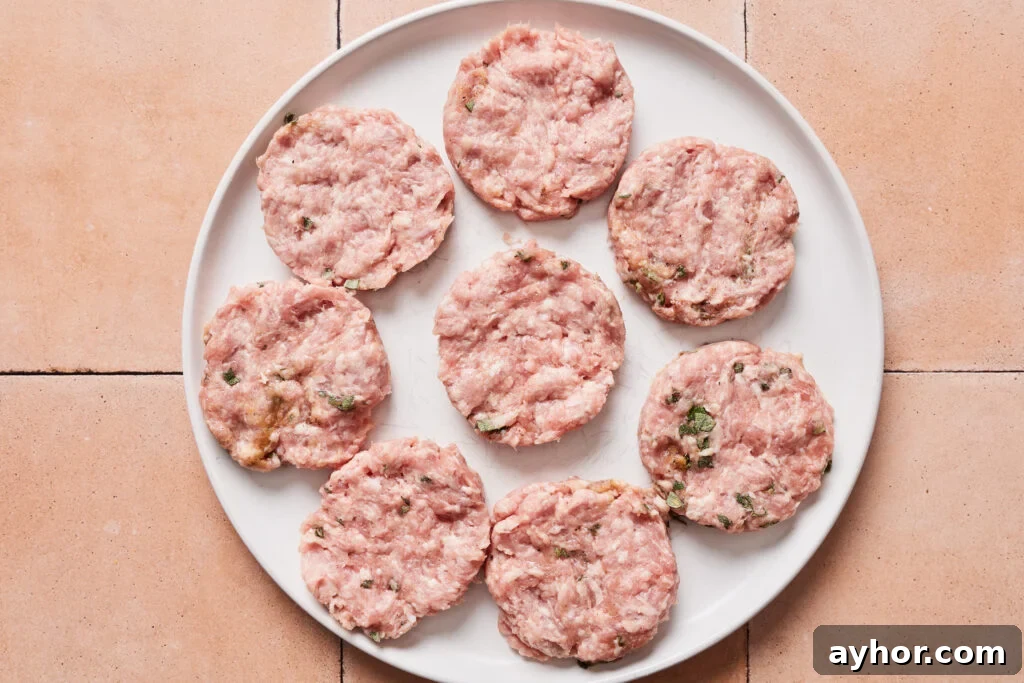 Pork breakfast sausage shaped into 6 patties on a plate
