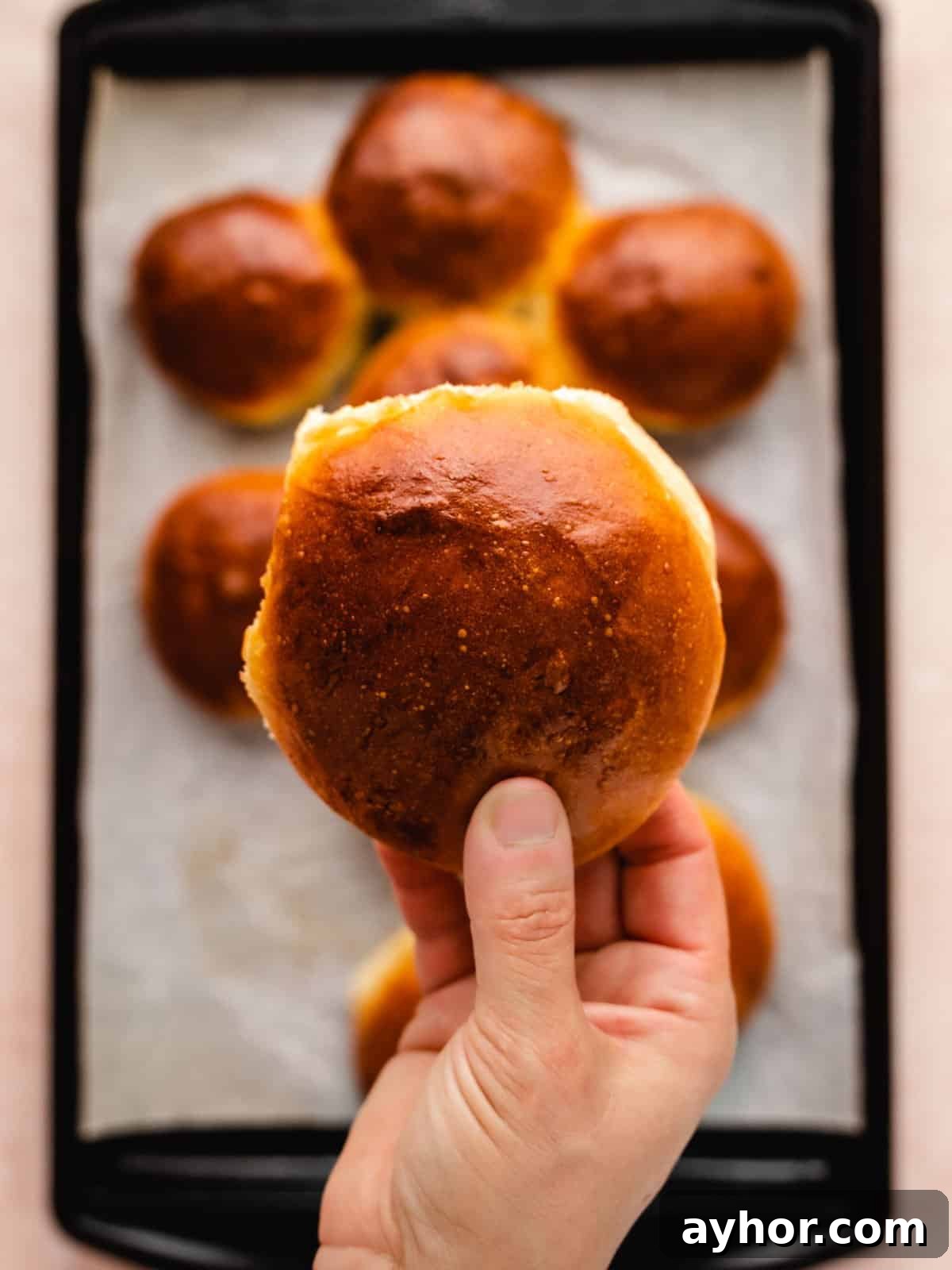hand holding a homemade brioche hamburger bun