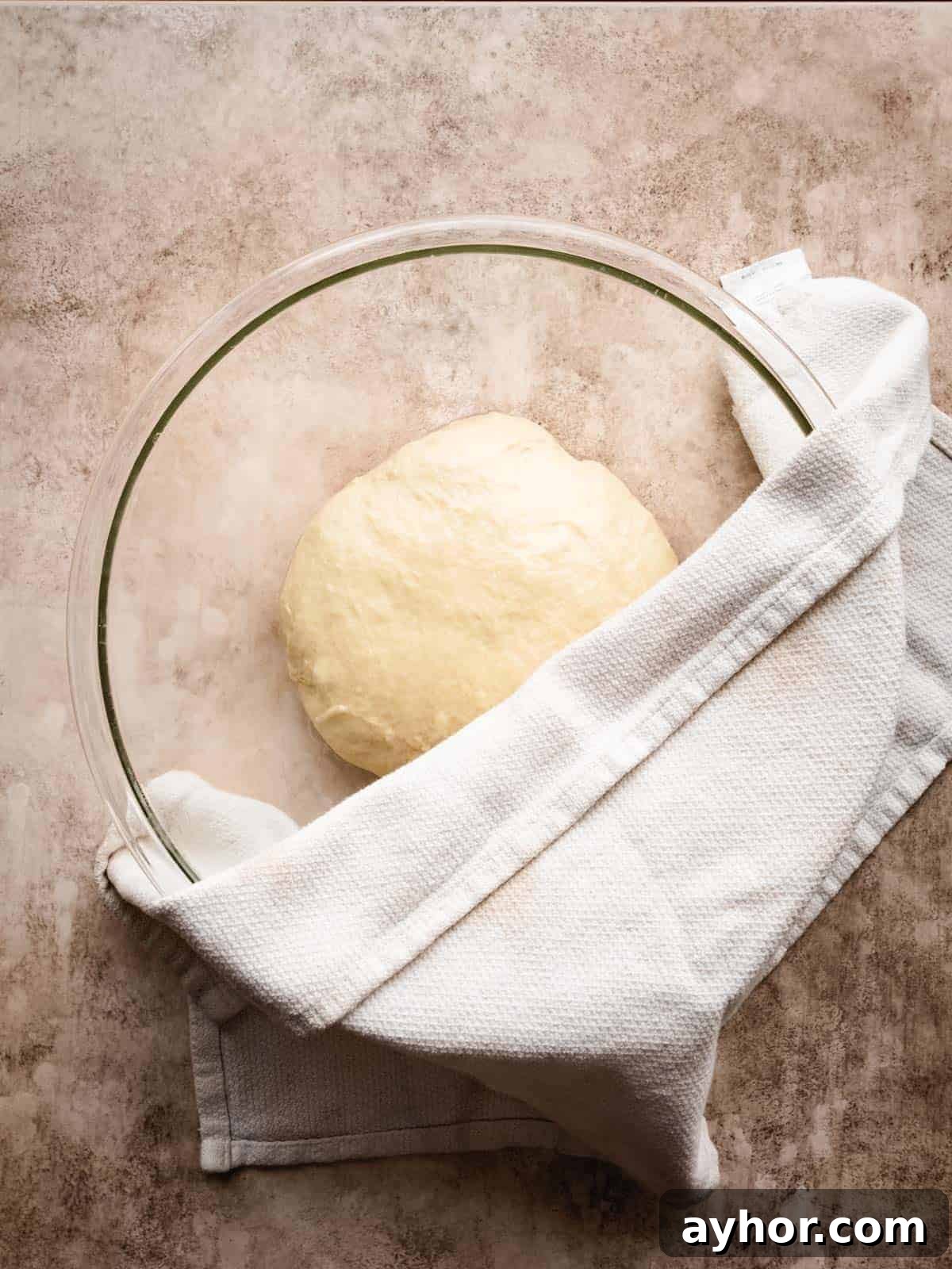 covering brioche dough to rise
