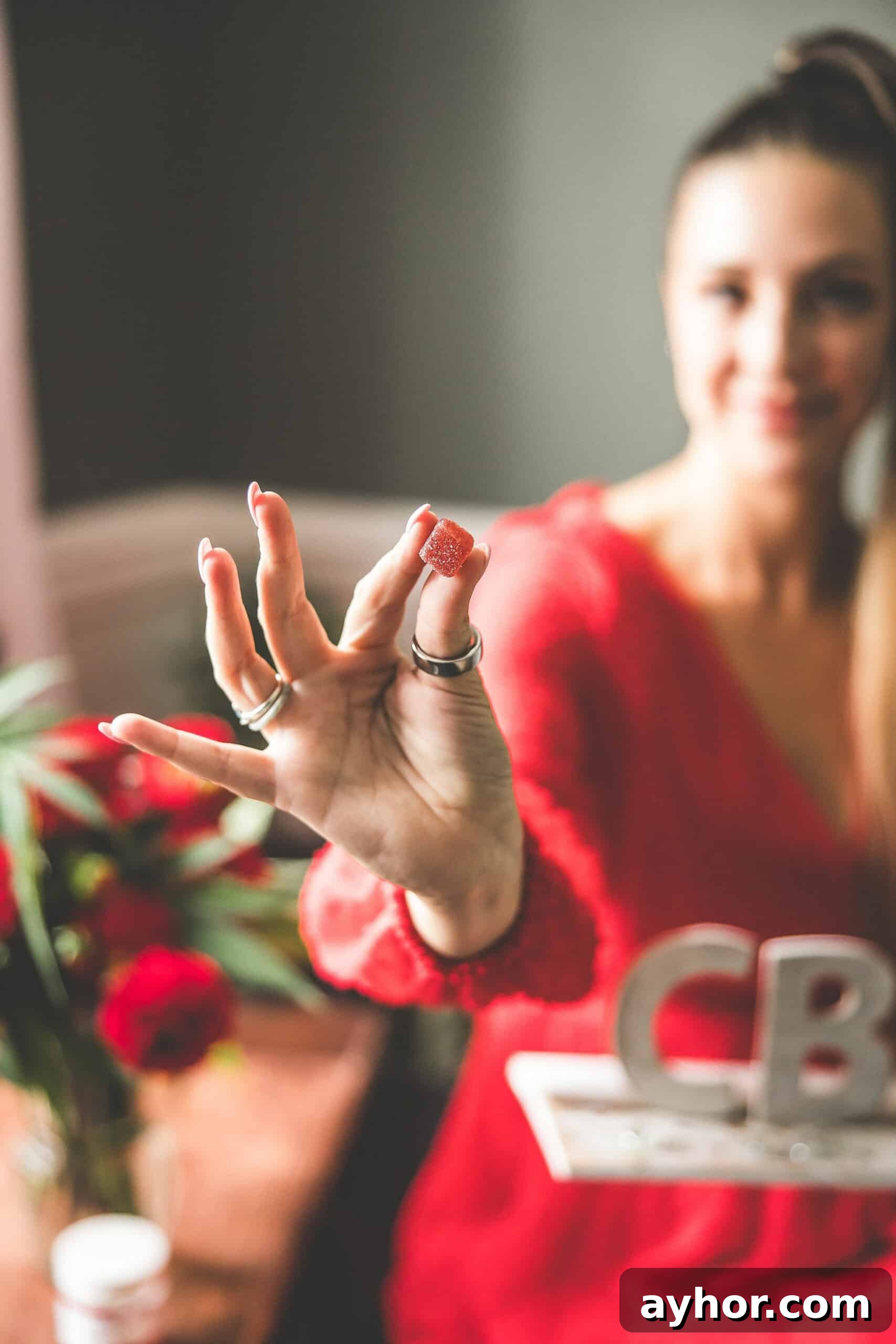 CBD for Wellness: A Complete Guide to Uses, Benefits, and Dosage 7 A picture of Emily Kyle holding a CBD sign.