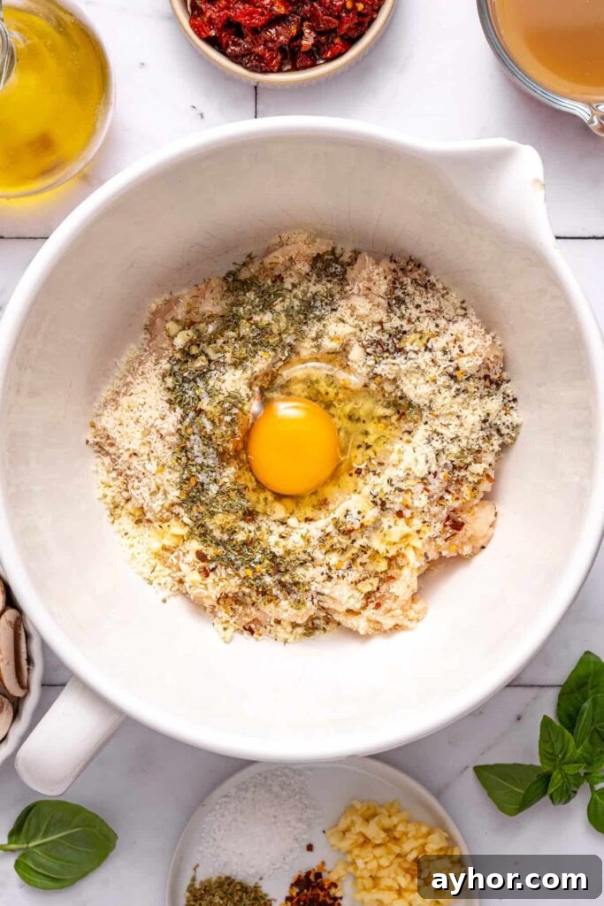 Bowl of seasoned ground chicken mixture for marry me chicken meatballs recipe