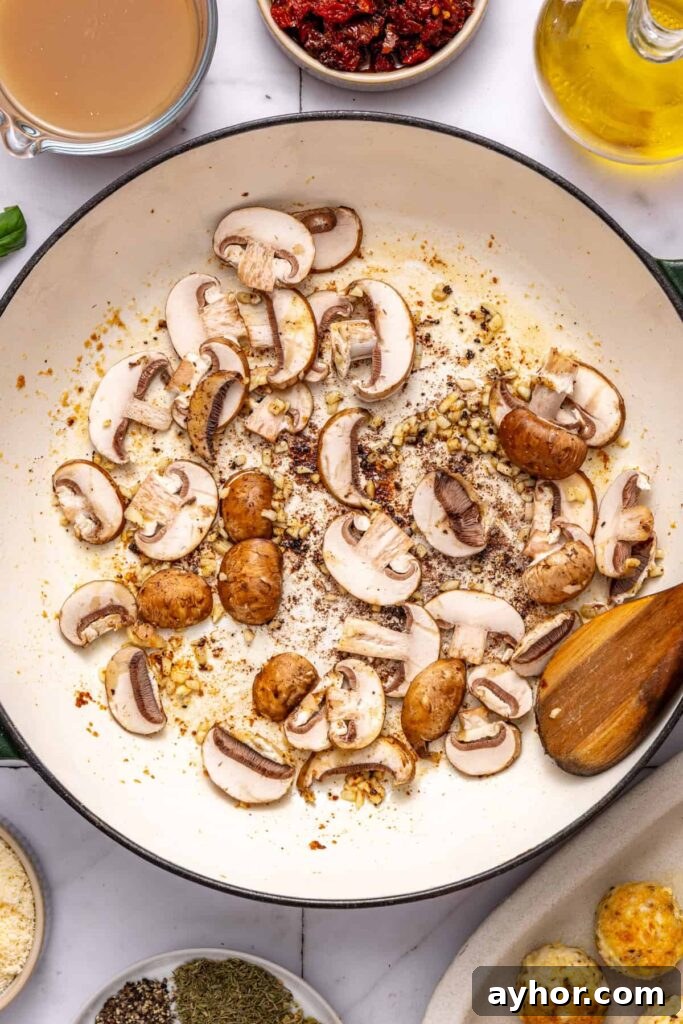 Cooking sliced mushrooms in skillet for creamy chicken meatball recipe