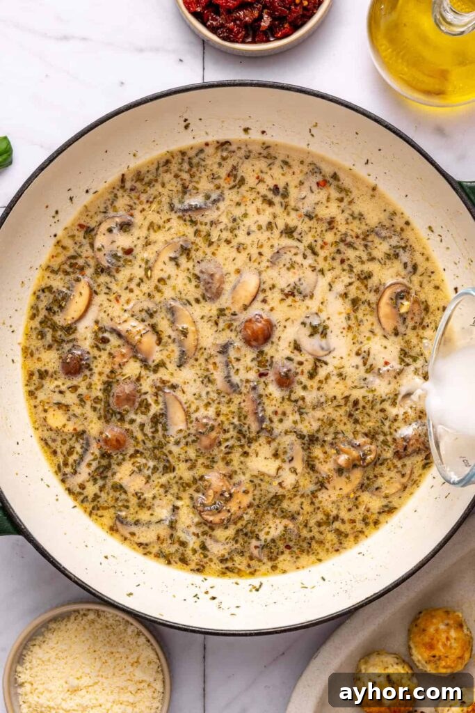 adding arrowroot slurry to thicken sauce for chicken meatballs