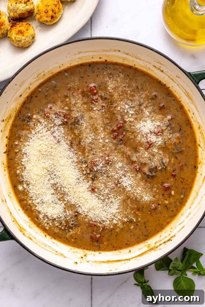 Adding Parmesan to sauce for rich chicken meatballs