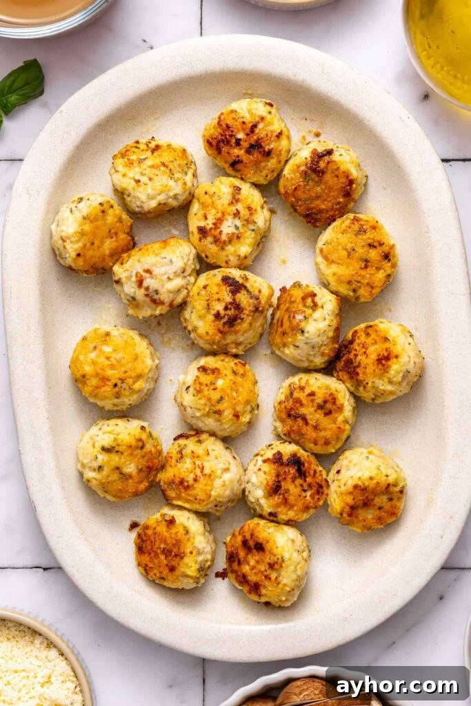 marry me chicken meatballs cooked and resting on a serving tray before going back in skillet