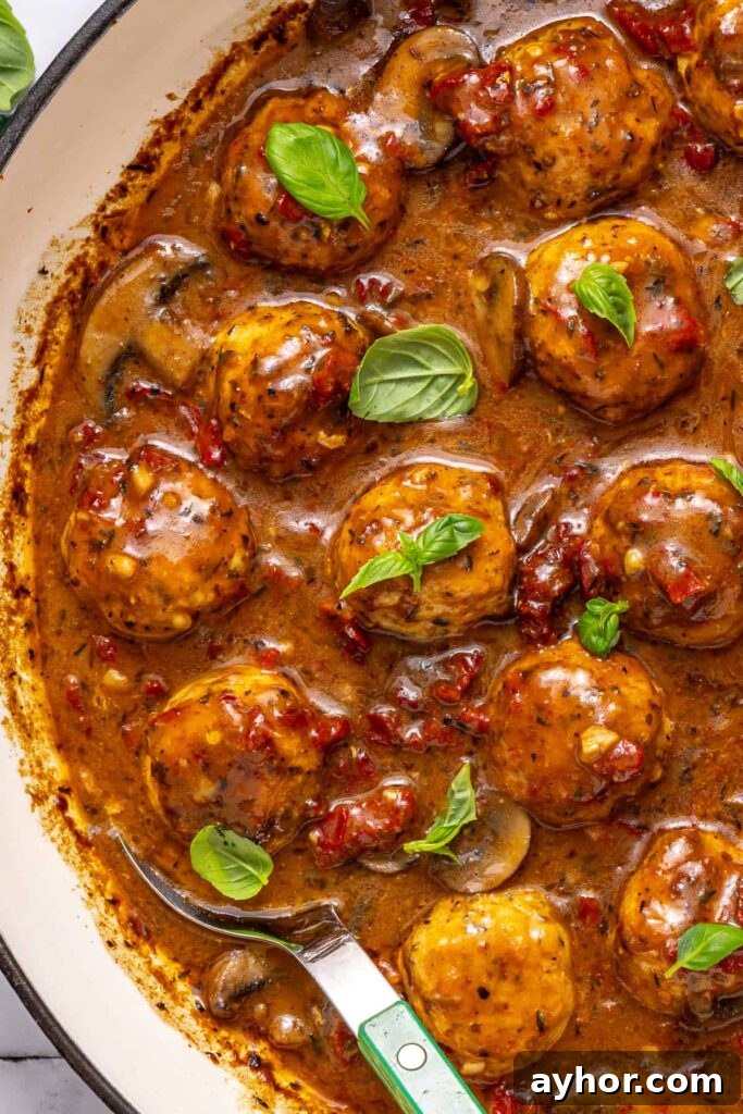 Marry me chicken meatballs with basil garnish in creamy sauce