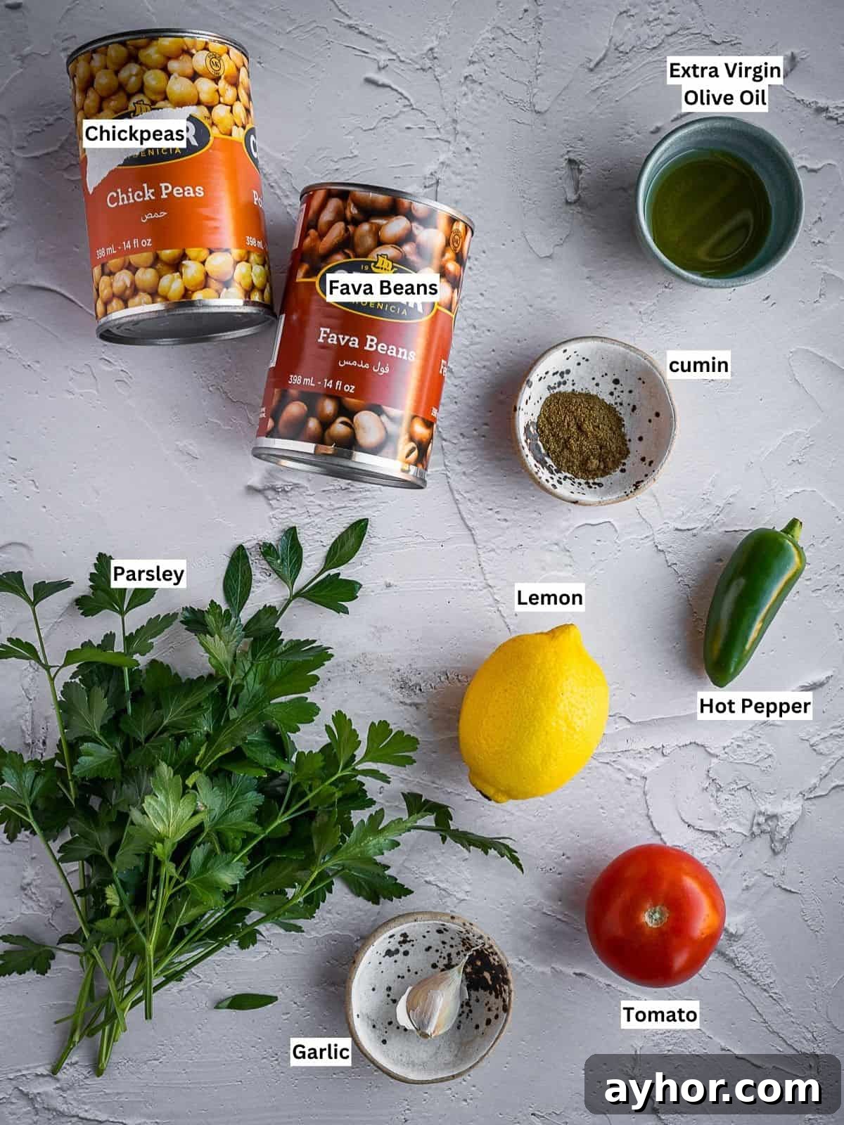Levantine Ful Medames: Classic Chickpea & Fava Bean Stew Recipe 3 Individually labeled ingredients for this recipe on a board.