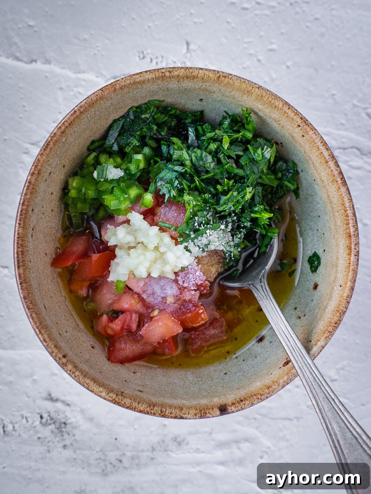 Levantine Ful Medames: Classic Chickpea & Fava Bean Stew Recipe 6 Bowl with chopped tomatoes, herbs and garlic.