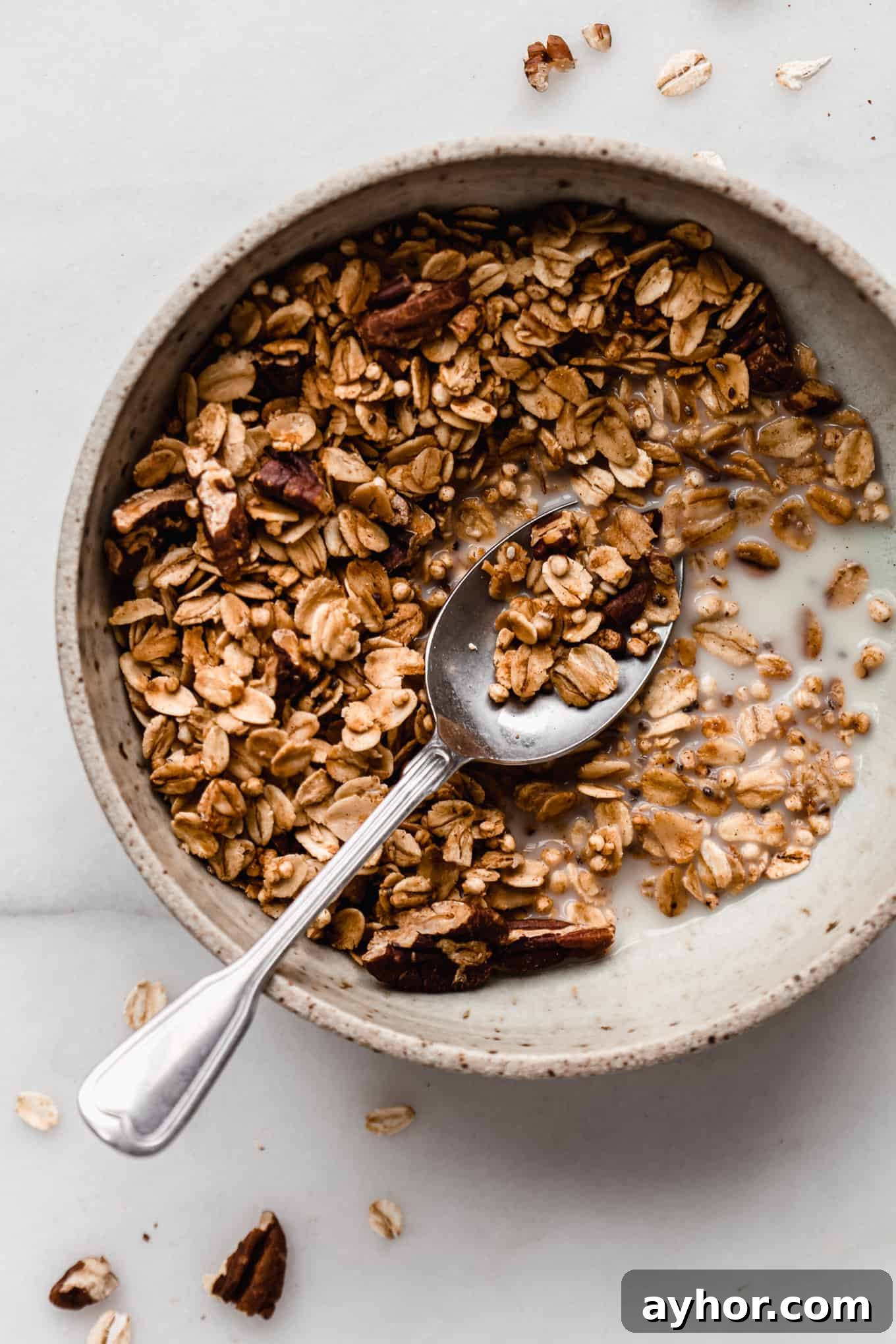 maple pecan granola in a bowl with a spoon