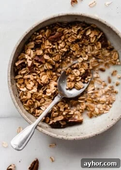 maple pecan granola in a bowl with a spoon
