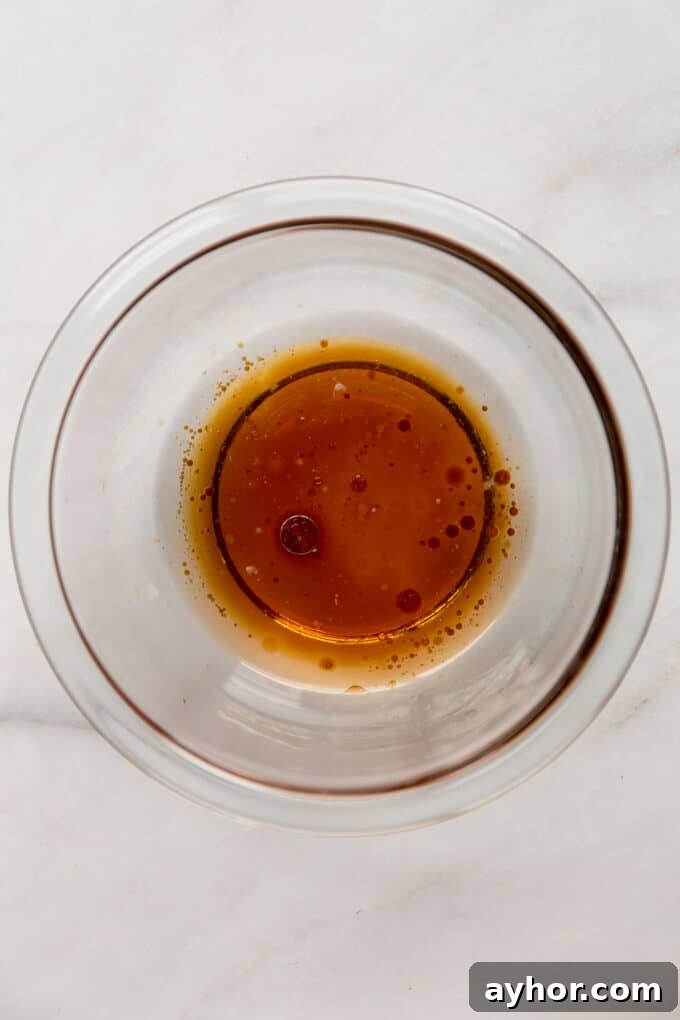 coconut oil, maple syrup and vanilla extract in a clear mixing bowl