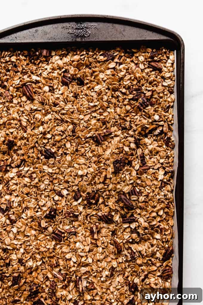 maple pecan granola toasted on a baking sheet