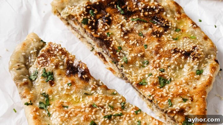 Baked Keema Naan cut in half and sprinkled with cilantro