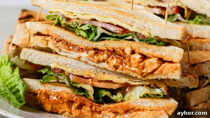 A plate stacked with club sandwiches