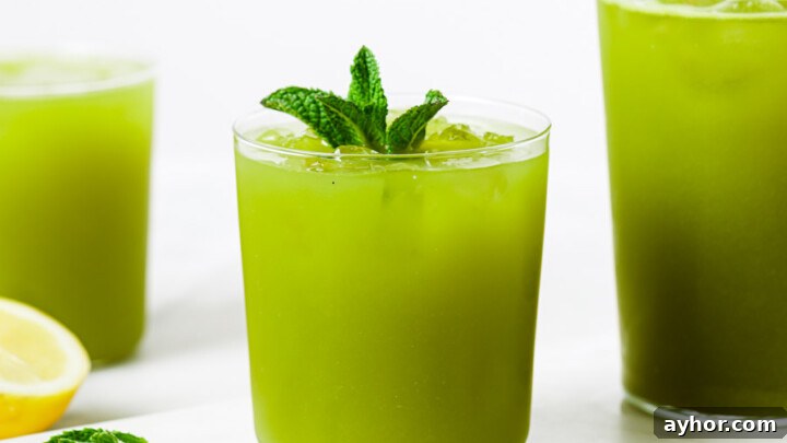 Mint Lemonade in glasses topped with a mint sprig