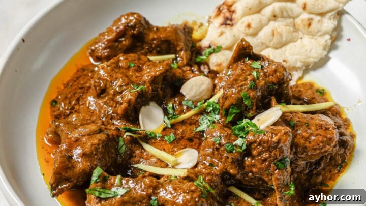 Mutton Korma garnished with almonds and ginger