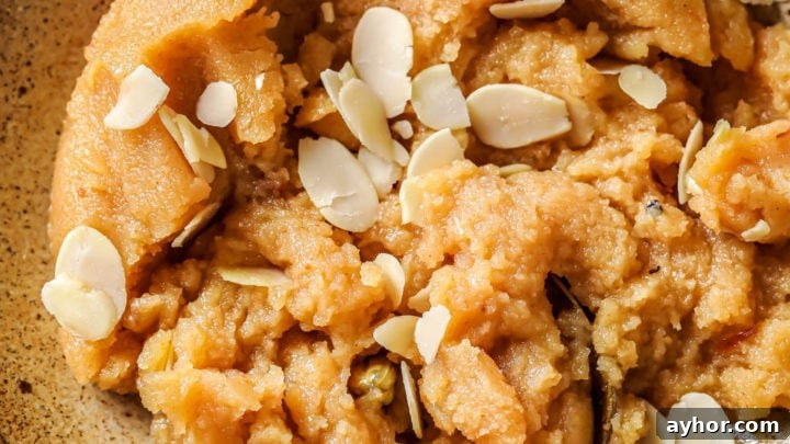 Sooji ka Halwa in a bowl garnished with blanched, slivered almonds.