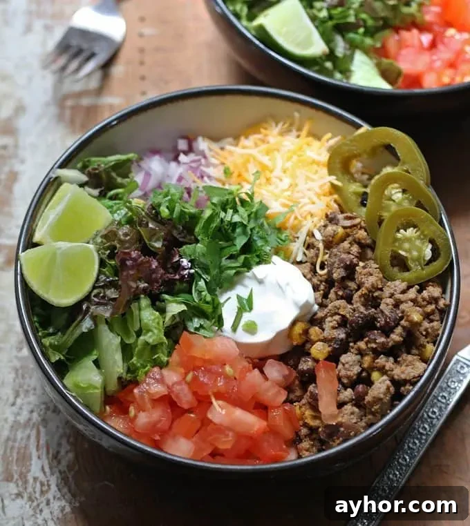 Loaded Burrito Bowls Recipe: Flavorful Chicken & Veggie Bowls 3 Loaded burrito bowls with rice, seasoned beef, beans, corn and fresh toppings.