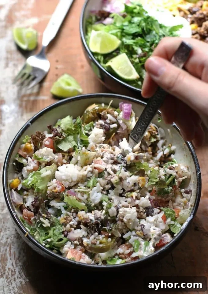 Loaded Burrito Bowls Recipe: Flavorful Chicken & Veggie Bowls 4 Bowls piled with seasoned beef, beans, corn and toppings.