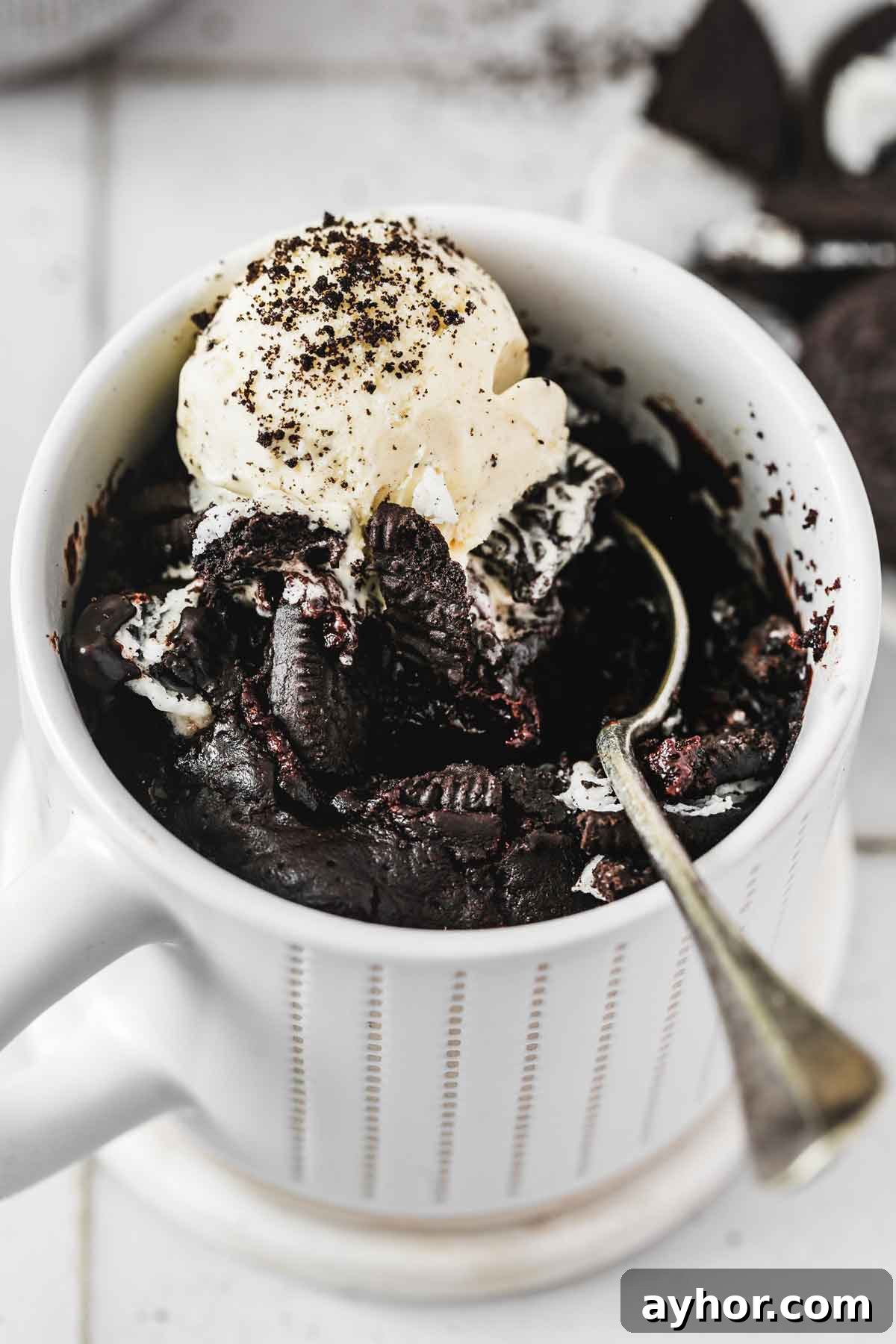 oreo mug cake served warm with vanilla ice cream and crushed Oreos