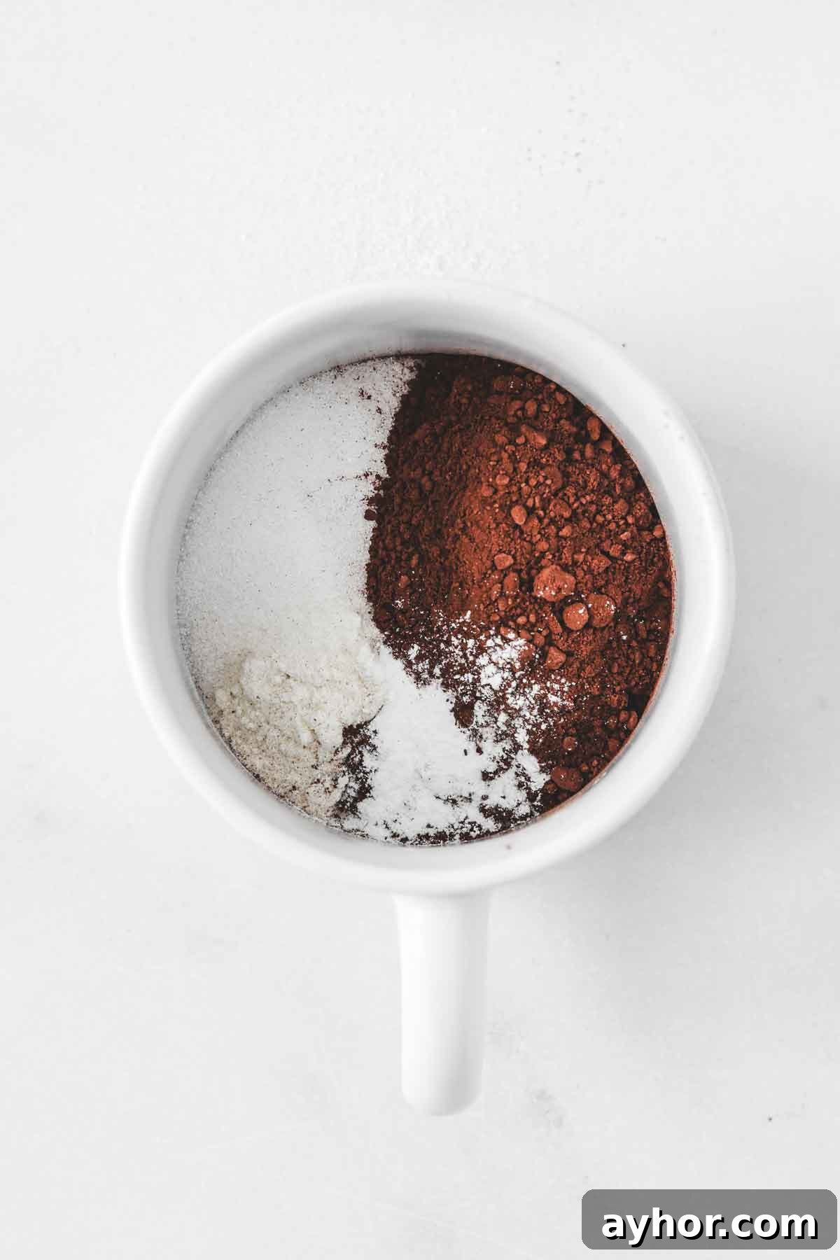 dry ingredients for oreo mug cake in a white mug