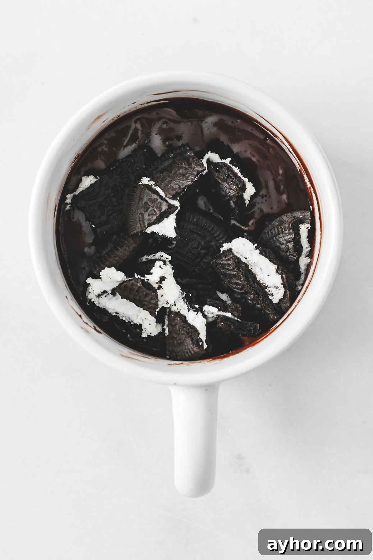 oreo pieces mixed into chocolate mug cake batter