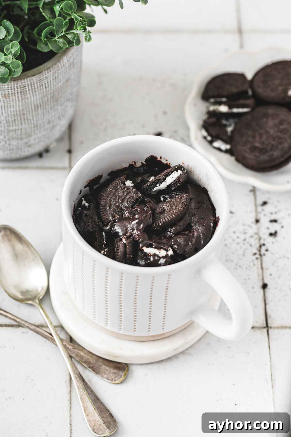 freshly baked oreo mug cake in a white mug