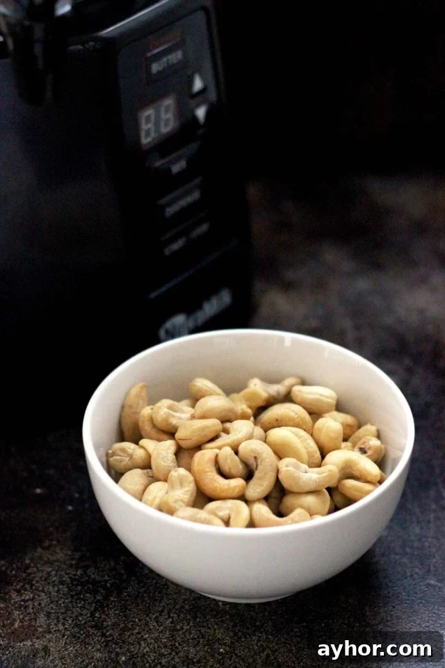 Healthy Vegan Pumpkin Spice Latte - The NutraMilk and a Bowl of Cashews on the Dark Table