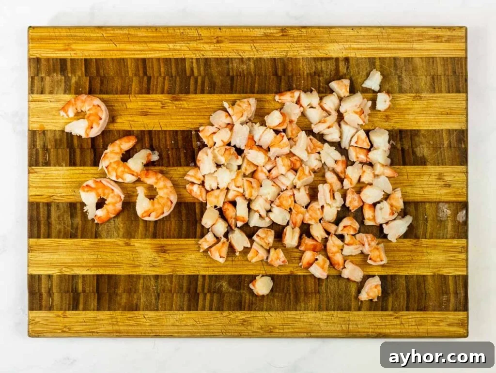 Authentic Mexican Shrimp Cocktail Recipe — Zesty Seafood Ceviche 5 Chopped shrimp on a cutting board