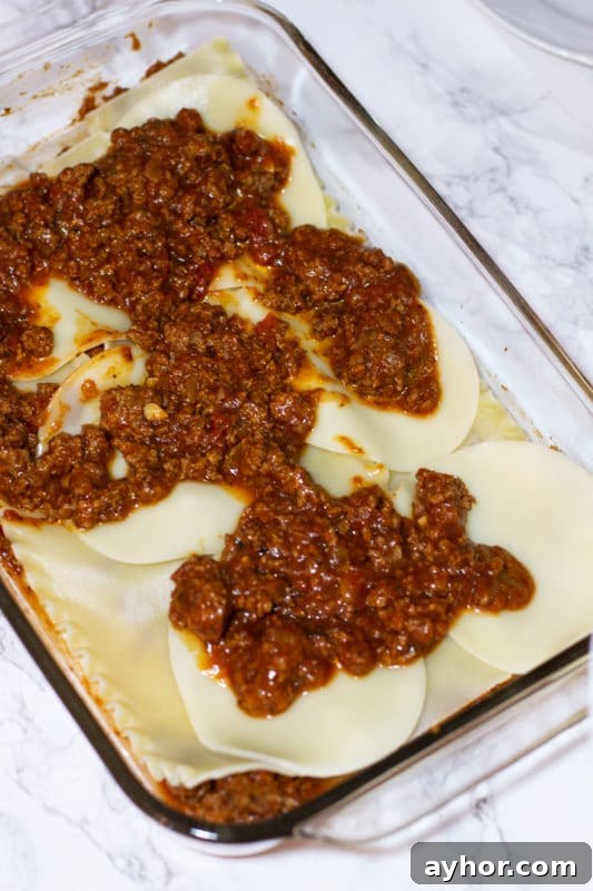 Classic Homemade Lasagna Recipe for Rich, Cheesy Layers 13 Sauce on provolone.