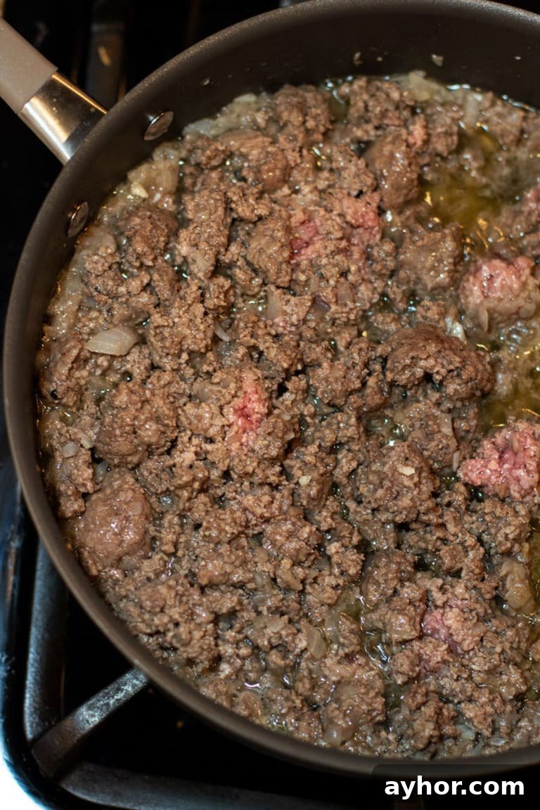 Classic Homemade Lasagna Recipe for Rich, Cheesy Layers 6 Ground beef and onions browning in a skillet.